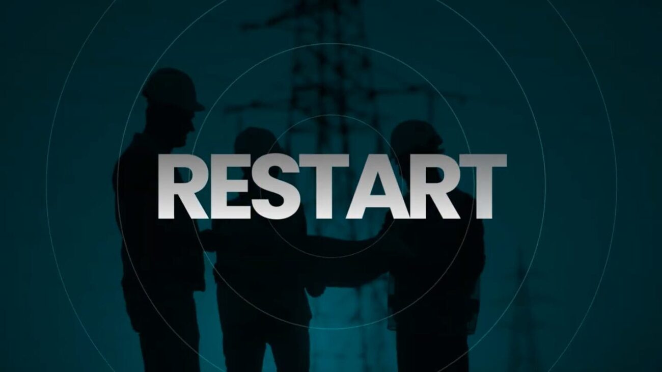 “Silhouettes of three construction workers wearing hard hats standing in front of power-line structures, with the word ‘RESTART’ in large bold letters overlaid in the centre of the image on a teal background.”